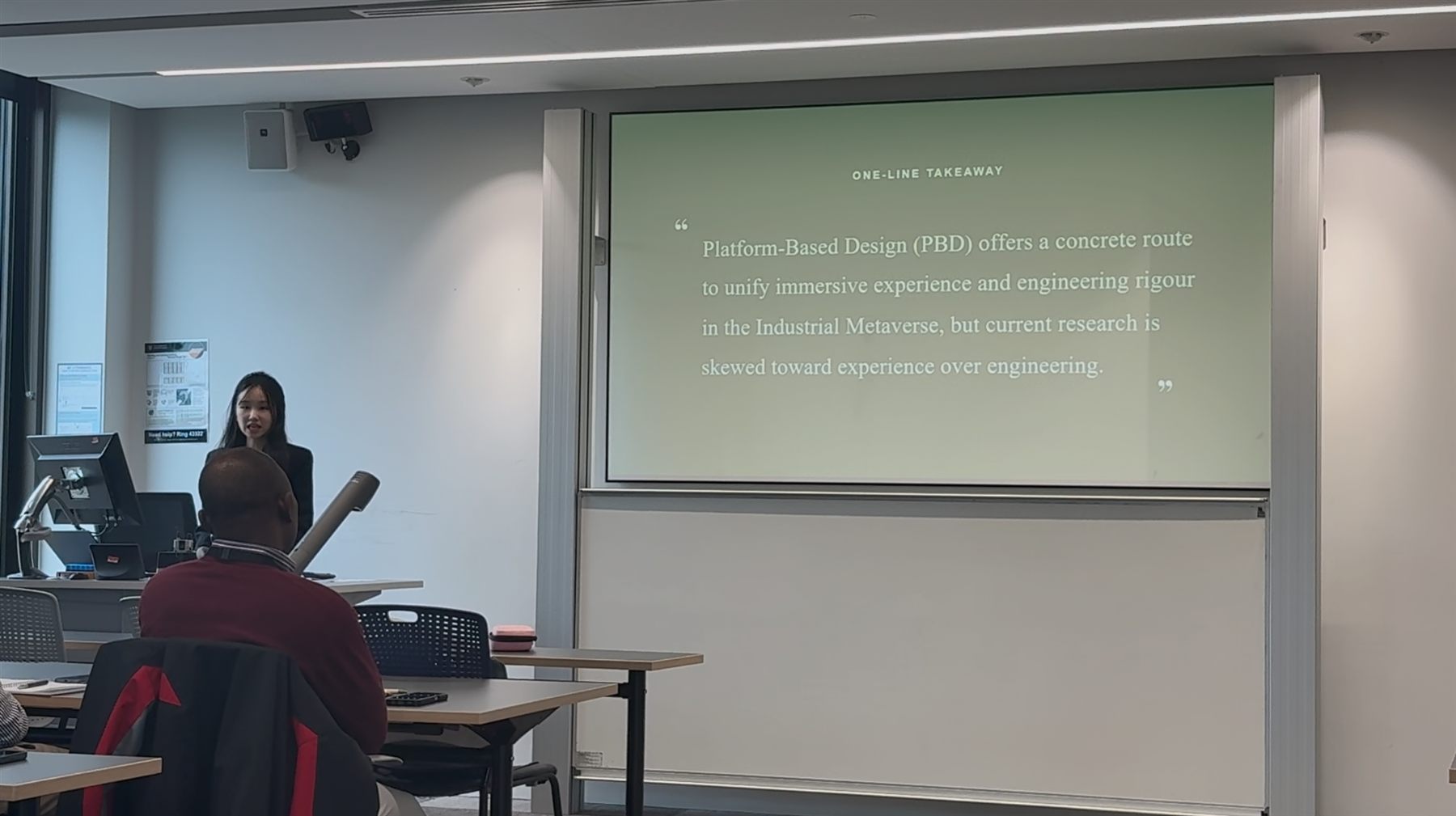 Research presentation session with projected key takeaway slide.