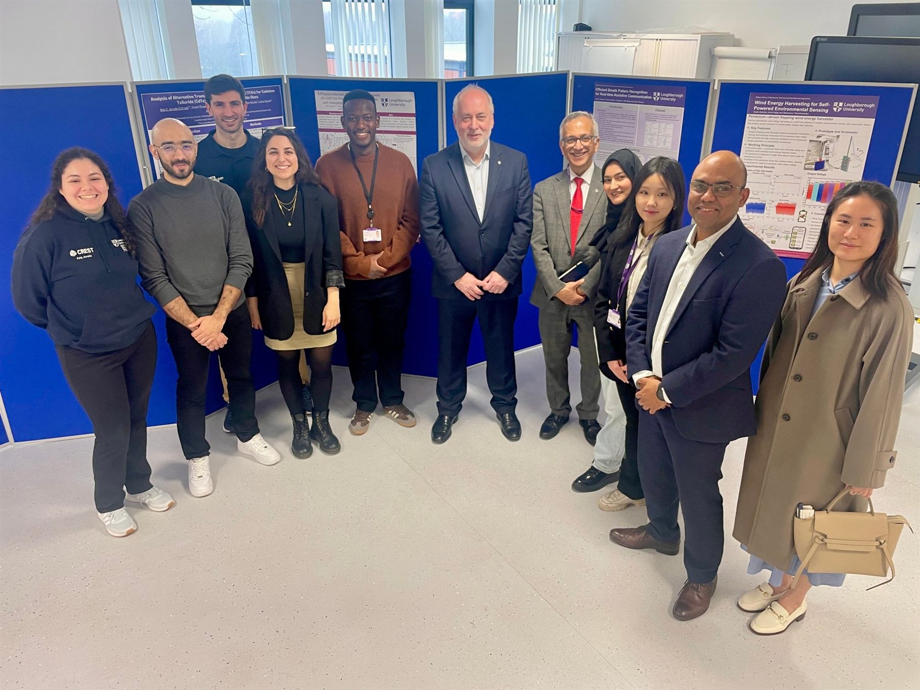 Research group photo with poster boards at Loughborough University.